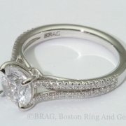 Round platinum halo with 18k rose gold scroll filigree under bezel