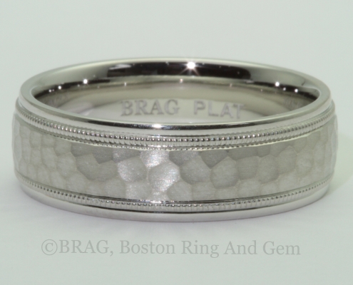 Platinum men's wedding ring with matte hammer center and mill grain edge