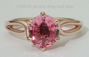 Padparadscha sapphire set in a 6 prong twisted 14k rose gold ring.