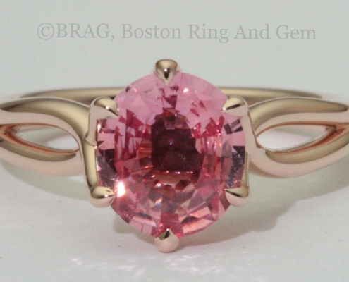 Padparadscha sapphire set in a 6 prong twisted 14k rose gold ring.