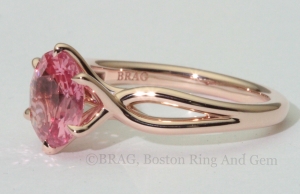 Padparadscha sapphire set in a 6 prong twisted 14k rose gold ring.