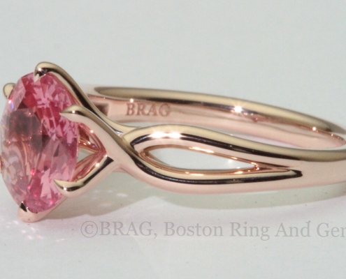 Padparadscha sapphire set in a 6 prong twisted 14k rose gold ring.