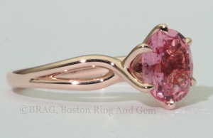 Padparadscha sapphire set in a 6 prong twisted 14k rose gold ring.