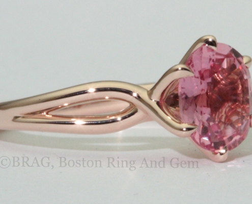 Padparadscha sapphire set in a 6 prong twisted 14k rose gold ring.
