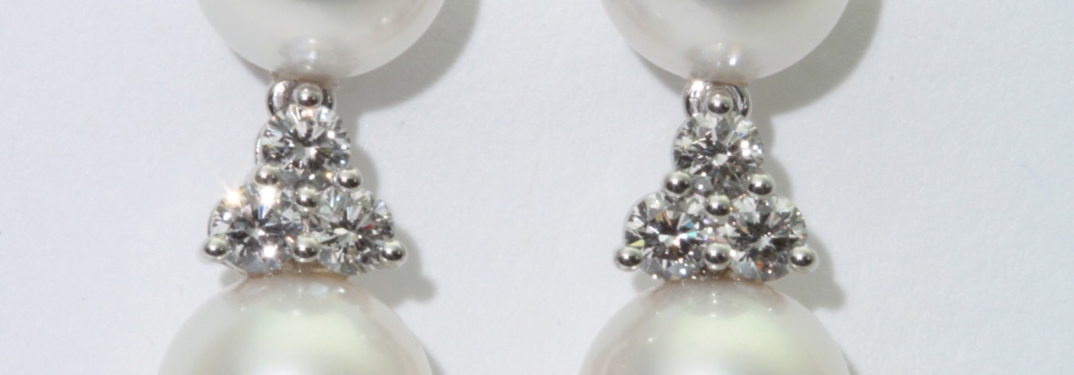 Pearl and diamond drop earrings set in platinu