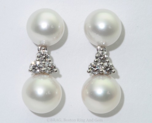 Pearl and diamond drop earrings set in platinu