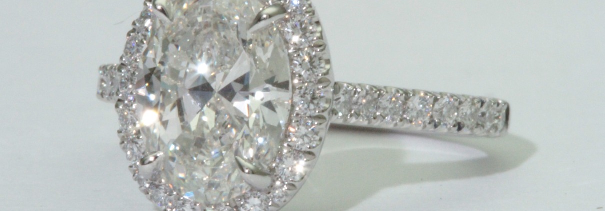 Oval brilliant cut diamond set in a fishtail set Oval halo on a cathedral band