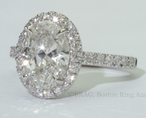 Oval brilliant cut diamond set in a fishtail set Oval halo on a cathedral band