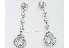 A pair of diamond drop earrings. Halo base, 3 prong set diamonds with pair shaped double hoops.