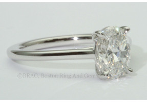 Oval cut diamond set in thin platinum cathedral Solitaire Engagement Ring