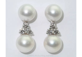 Pearl and diamond drop earrings set in platinum