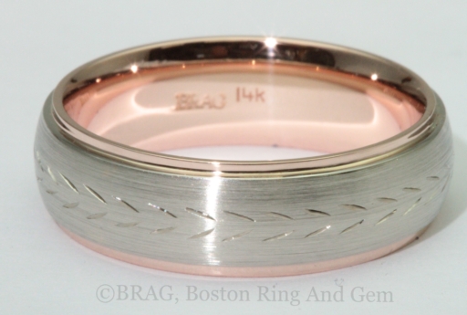 Two tone 14k white and rose gold wedding ring with hand carved pattern.