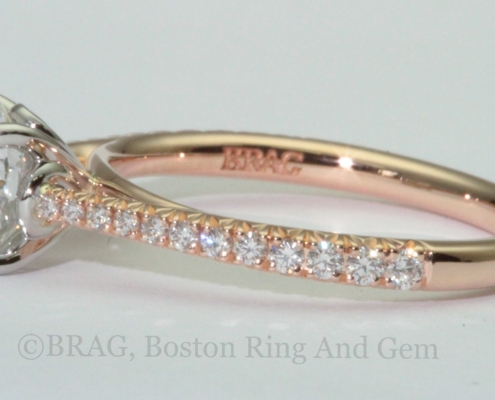 Round brilliant cut diamond set in a two tone solitaire engagement ring. 18k rose gold tapered cathedral band with French cut set diamonds with looped four prong platinum basket
