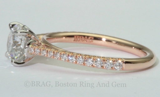 Round brilliant cut diamond set in a two tone solitaire engagement ring. 18k rose gold tapered cathedral band with French cut set diamonds with looped four prong platinum basket