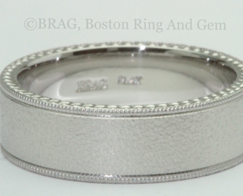 Platinum Men’s wedding ring: 7mm wide flat with mill grain edge and carved sidewalls and band blast finish